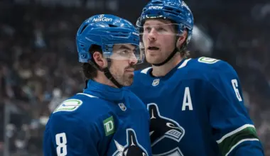 Vancouver Canucks forward Brock Boeser (6) talks with forward Conor Garland (8) during a stop in play against the San Jose Sharks in the second period at Rogers Arena.