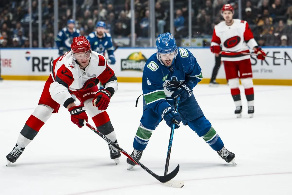 Carolina Hurricanes forward Andrei Svechnikov (37) stick checks Vancouver Canucks forward Conor Garland (8) in the third period at Rogers Arena.