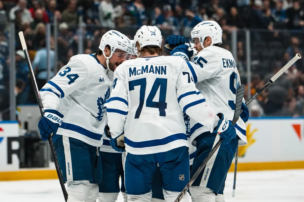 Toronto Maple Leafs forward Auston Matthews (34) and defenseman Troy Stecher (28) and forward Max Domi (11) and defenseman Oliver Ekman-Larsson (95) and forward Bobby McMann (74) celebrate Domi