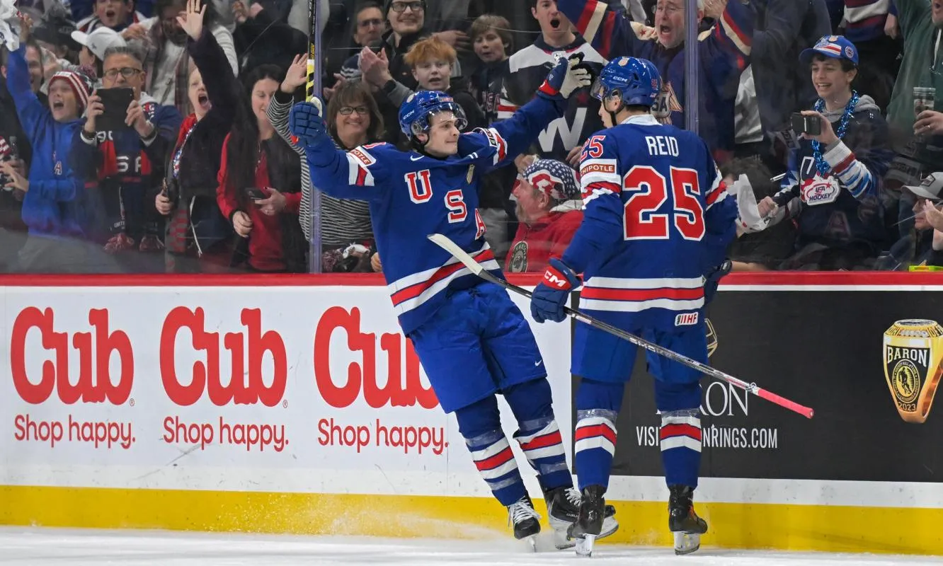 USA defensemen Chase Reid (25) celebrates his power play goal against Sweden with forward James Hagens (10) during the second period in group play during the 2026 IIHF World Junior Championship at Grand Casino Arena