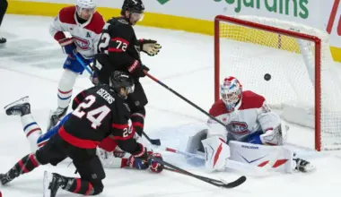 Montreal Canadiens goalie Jacob Fowler (32) makes a save in front of Ottawa Senators center Dylan Cozens (24) in the third period at the Canadian Tire Centre.