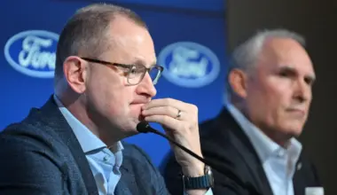 Toronto Maple Leafs general manager Brad Treliving listens to a question during a media conference to introduce new head coach Craig Berube (right) at Ford Performance Centre