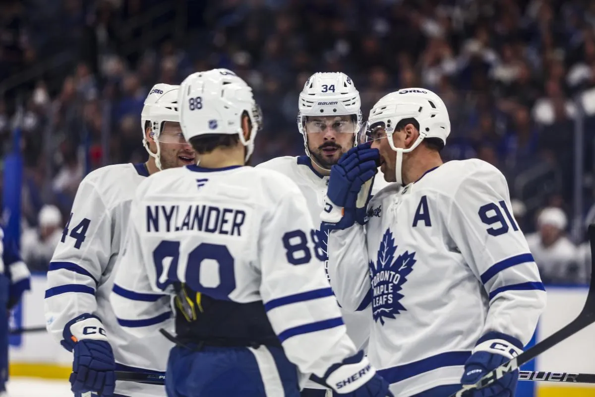 Toronto Maple Leafs forward Auston Matthews (34), defenseman Morgan Rielly (44), forward William Nylander (88), and forward John Tavares (91) huddle before a face-off against the Tampa Bay Lightning during the second period at Benchmark International Arena.