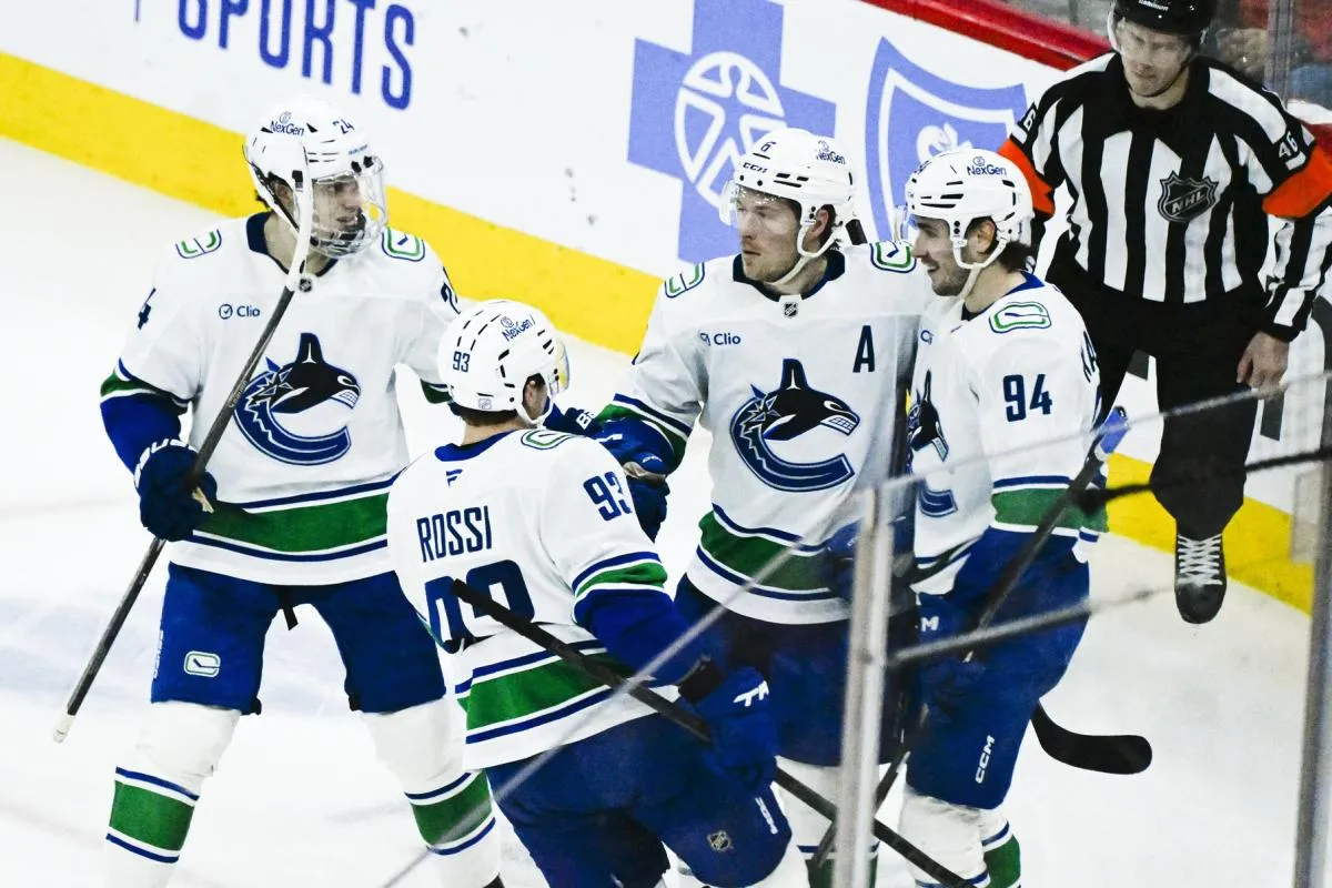 Vancouver Canucks right wing Brock Boeser (6), second from right, celebrates with teammates after scoring a goal against the Chicago Blackhawks during the third period at United Center.