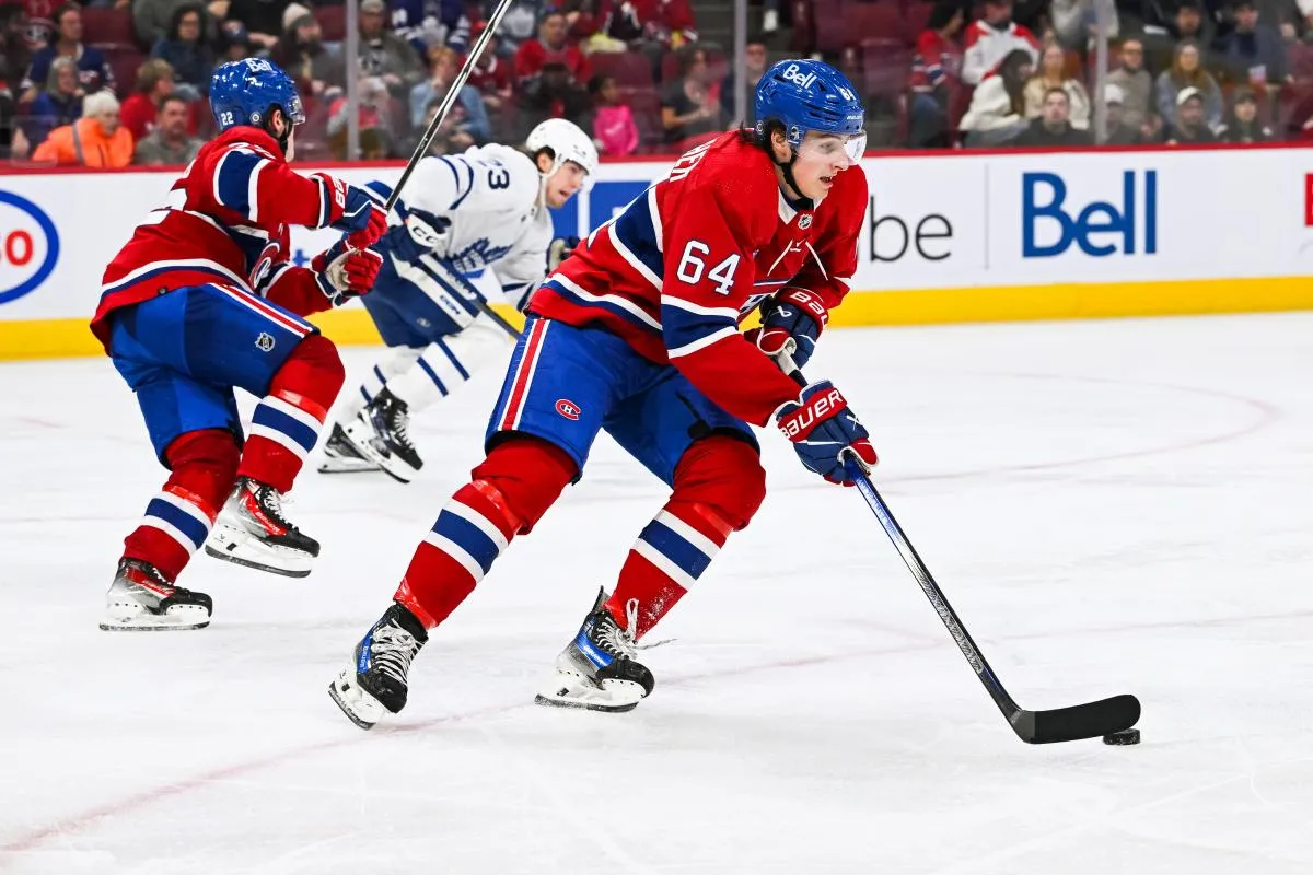 Montreal Canadiens defenseman David Reinbacher (64) plays the puck against the Toronto Maple Leafs during the third period at Bell Centre.