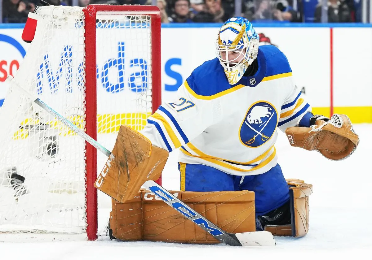 Buffalo Sabres goaltender Devon Levi (27) steers the puck to the side of the net against the Toronto Maple Leafs during the first period at Scotiabank Arena.