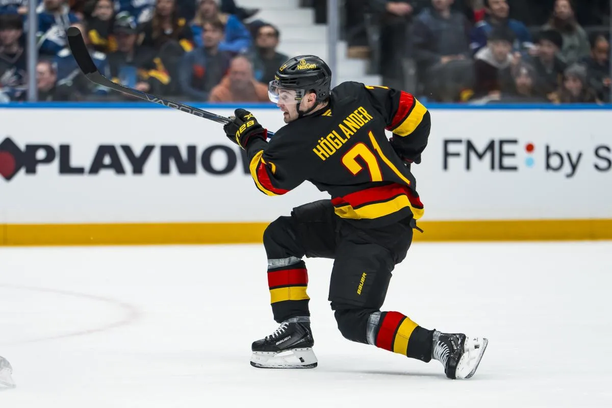 Vancouver Canucks forward Nils Hoglander (21) shoots against the Dallas Stars in the second period at Rogers Arena.