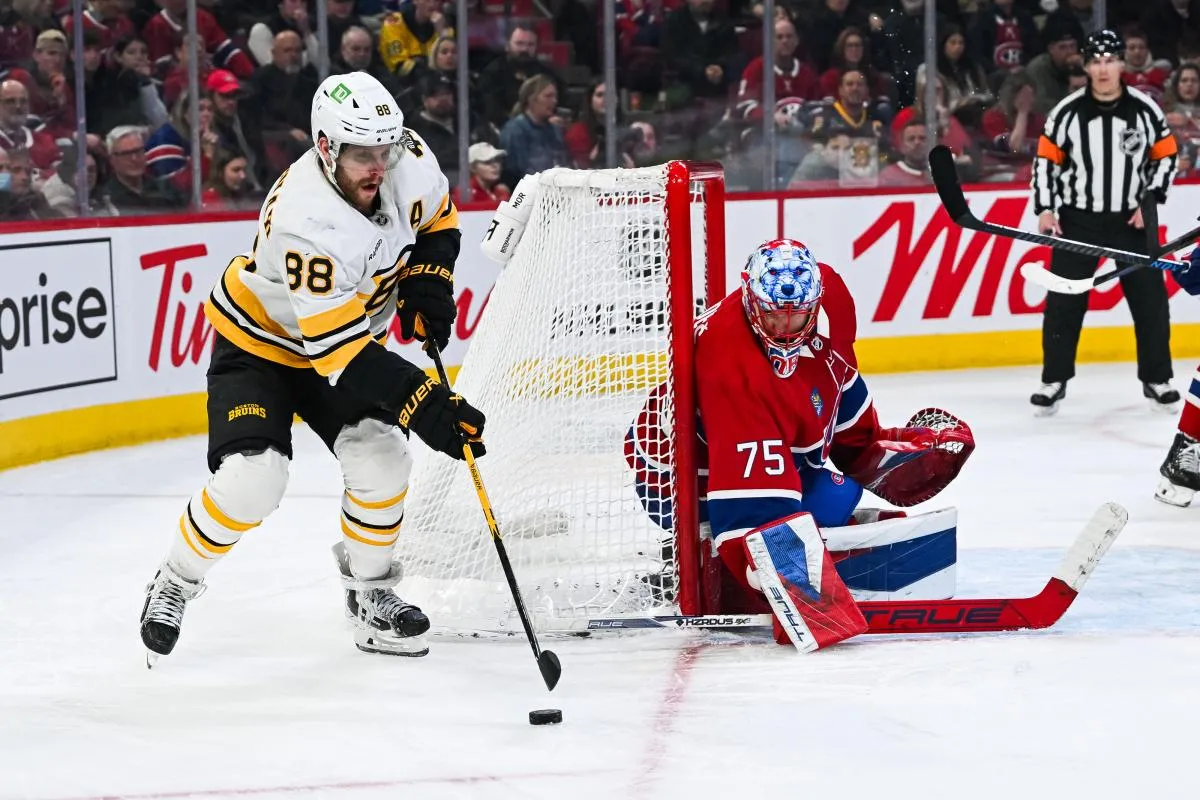 Boston Bruins right wing David Pastrnak (88) plays the puck against Montreal Canadiens goalie Jakub Dobes (75) during the third period at Bell Centre.