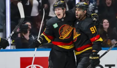 Vancouver Canucks forward Aatu Raty (54) and forward Evander Kane (91) celebrate Raty