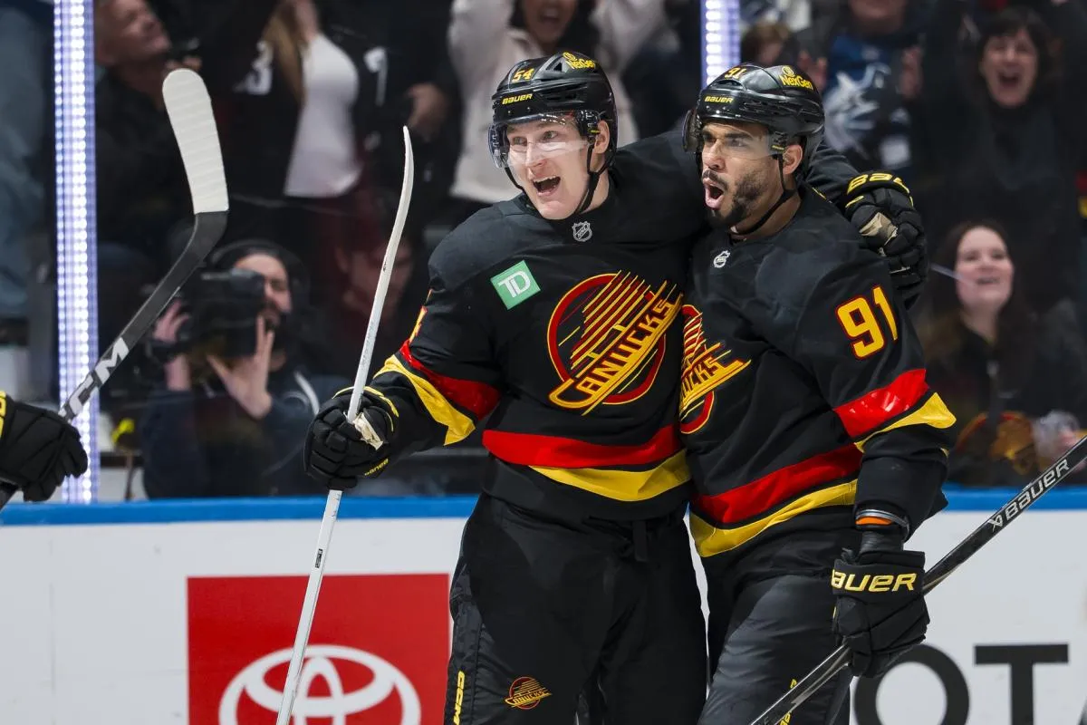 Vancouver Canucks forward Aatu Raty (54) and forward Evander Kane (91) celebrate Raty