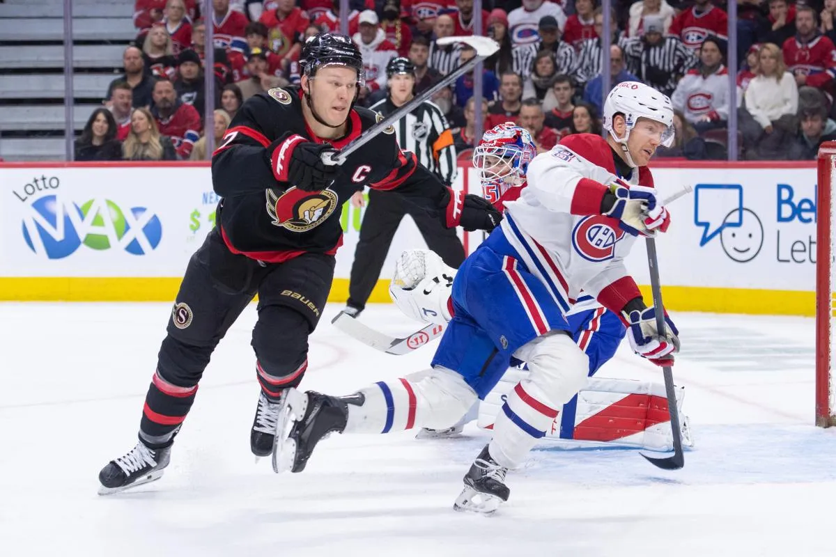 Ottawa Senators left wing Brady Tkachuk (7) and Montreal Canadiens defenseman Mike Matheson (8) chase the puck in the first period at the Canadian Tire Centre.