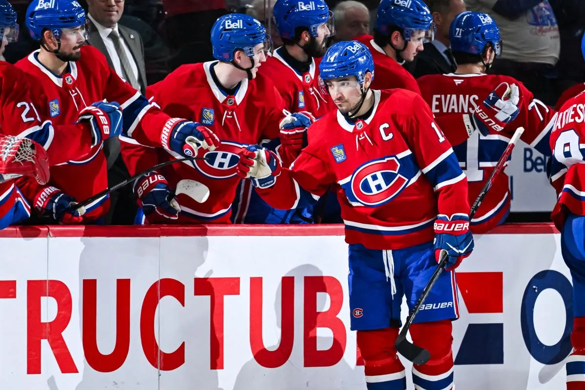 Montreal Canadiens center Nick Suzuki (14) celebrates with his teammates at the bench his goal against the Anaheim Ducks during the second period at Bell Centre.