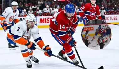 Montreal Canadiens center Nick Suzuki (14) plays the puck against New York Islanders defenseman Adam Pelech (3) during the first period at Bell Centre.