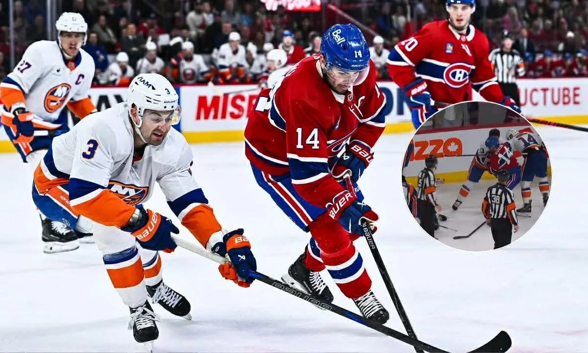 Montreal Canadiens center Nick Suzuki (14) plays the puck against New York Islanders defenseman Adam Pelech (3) during the first period at Bell Centre.