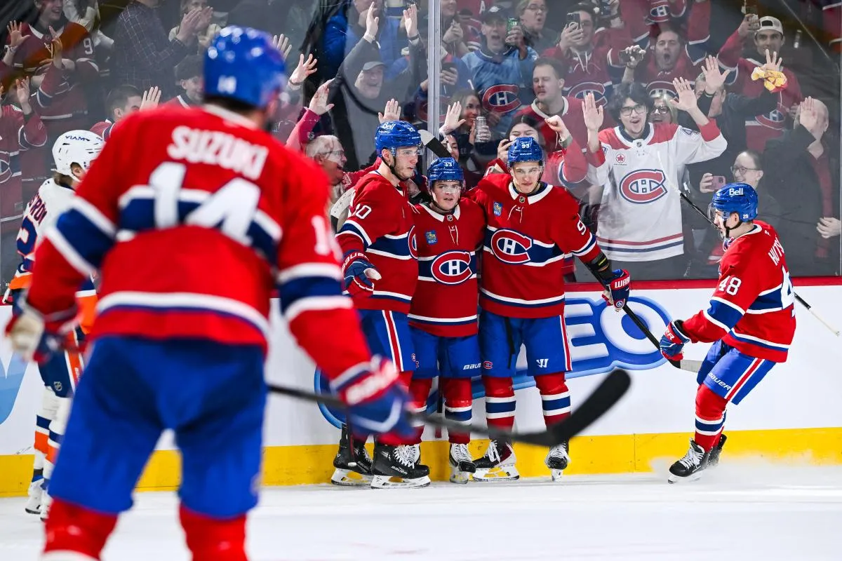 Montreal Canadiens right wing Cole Caufield (13) celebrates with eft wing Juraj Slafkovsky (20) and right wing Ivan Demidov (93) his third goal of the game against the New York Islanders during the third period at Bell Centre.