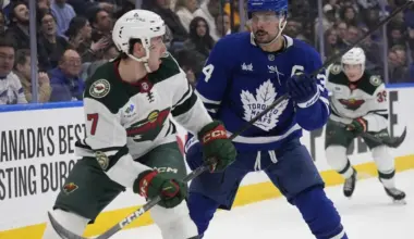 Minnesota Wild defenseman Brock Faber (7) skates against Toronto Maple Leafs forward Auston Matthews (34) during the first period at Scotiabank Arena.