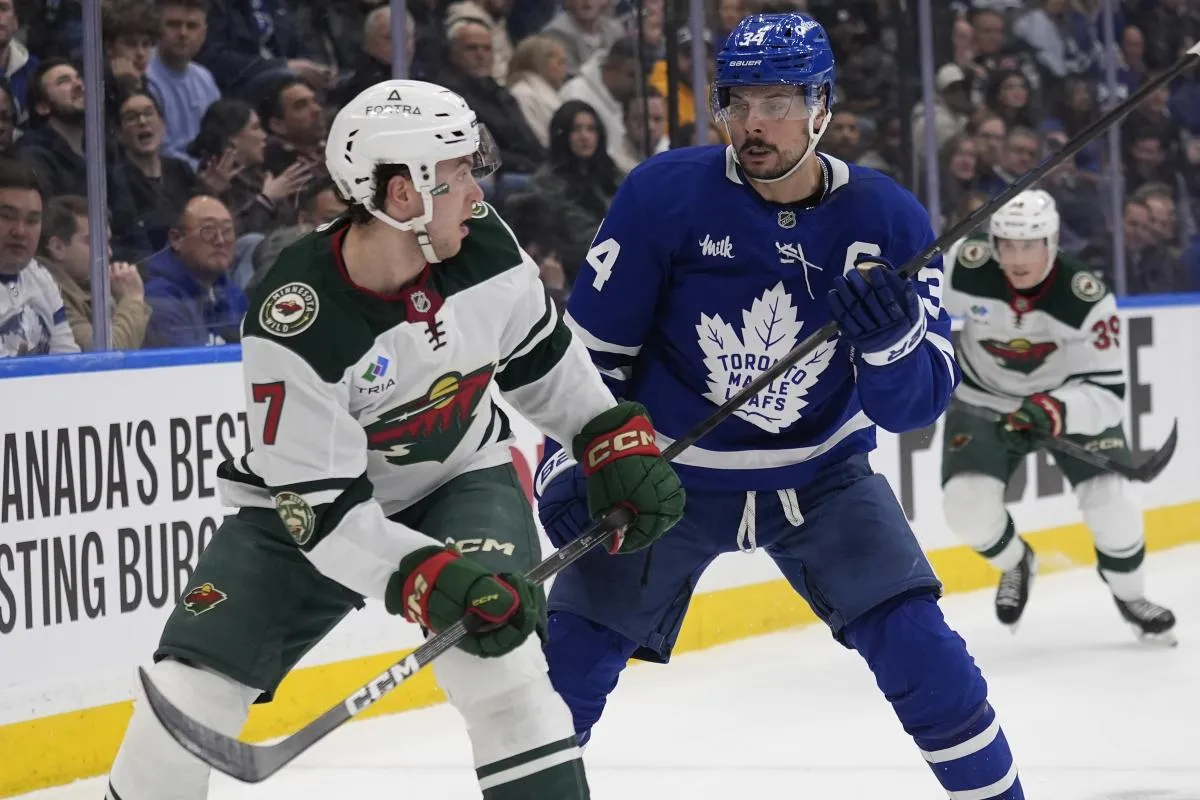 Minnesota Wild defenseman Brock Faber (7) skates against Toronto Maple Leafs forward Auston Matthews (34) during the first period at Scotiabank Arena.
