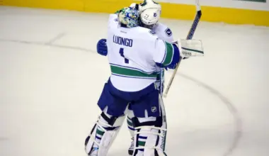 Vancouver Canucks goalie Roberto Luongo (1) is congratulated by center Manny Malhotra (27) after the game against the Colorado Avalanche at the Pepsi Center. The Canucks defeated the Avalanche 3-2 in a shootout.