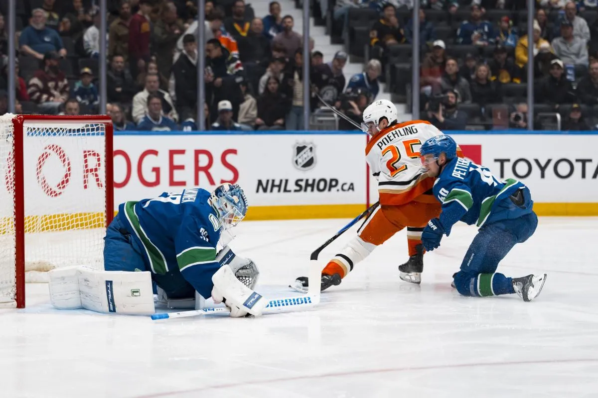 Vancouver Canucks forward Elias Pettersson (40) watches as goalie Kevin Lankinen (32) makes a save on Anaheim Ducks forward Ryan Poehling (25) in the first period at Rogers Arena.