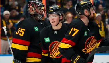 Vancouver Canucks goalie Thatcher Demko (35) and forward Braeden Cootes (80) and defenseman Filip Hronek (17) celebrate thier victory against the Calgary Flames at Rogers Arena.