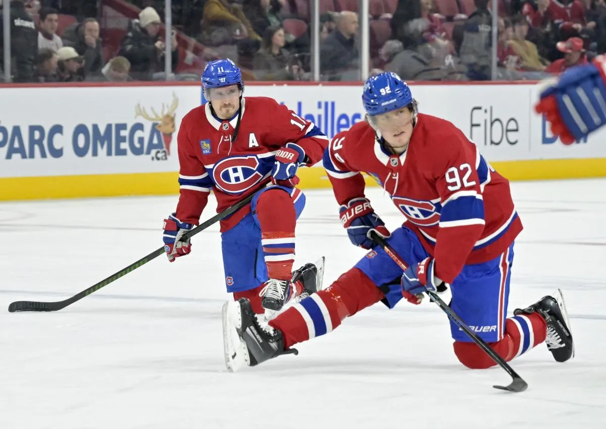 Montreal Canadiens forward Brendan Gallagher (11) and teammate Montreal Canadiens forward Patrik Laine (92) stretch during the warmup period before the game against the Buffalo Sabres at the Bell Centre.