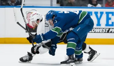 Vancouver Canucks defenseman Zeev Buium (24) battles with Los Angeles Kings forward Alex Laferriere (14) in the third period at Rogers Arena.