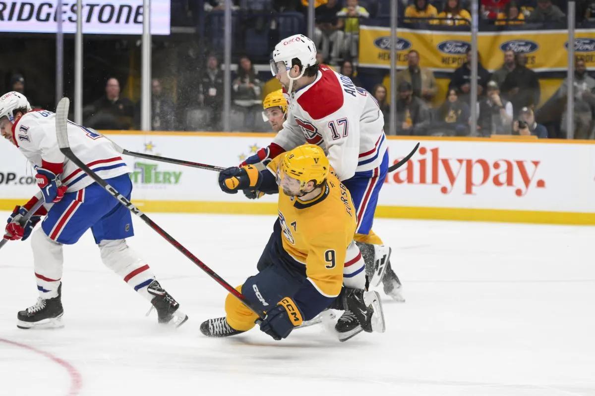 Montreal Canadiens right wing Josh Anderson (17) checks Nashville Predators left wing Filip Forsberg (9) during the third period at Bridgestone Arena.