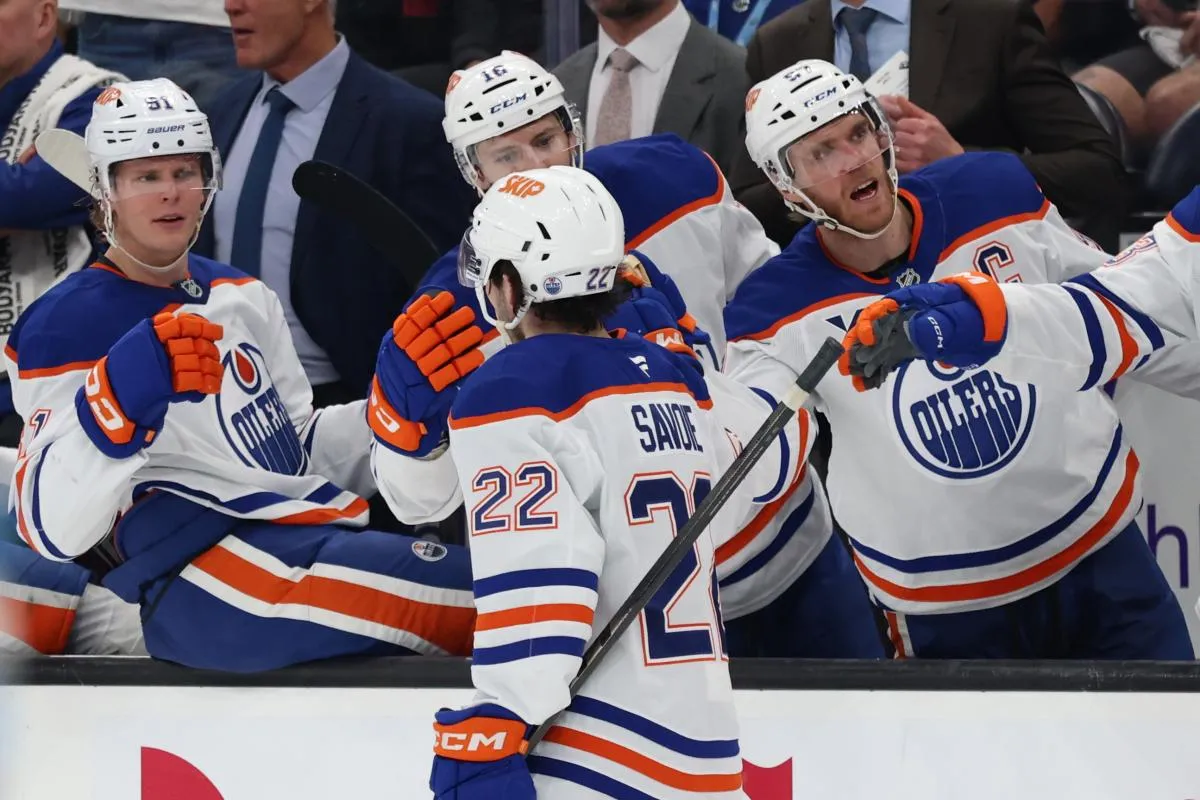 Edmonton Oilers center Matt Savoie (22) celebrates scoring a goal against the Utah Mammoth with bench players during the second period at Delta Center