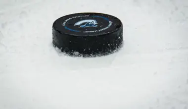 A puck lays on the ice during a stop in play in game between the Vancouver Canucks and Boston Bruins in the second period at Rogers Arena