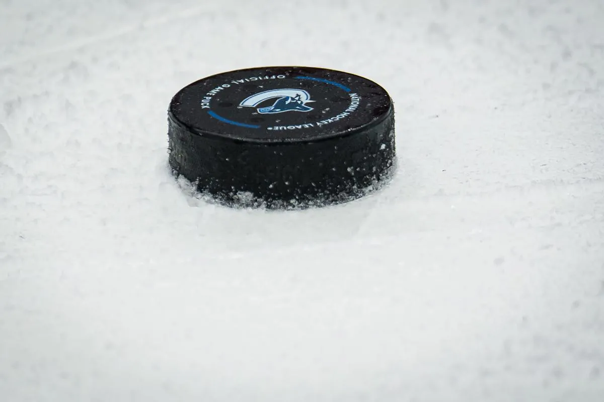 A puck lays on the ice during a stop in play in game between the Vancouver Canucks and Boston Bruins in the second period at Rogers Arena