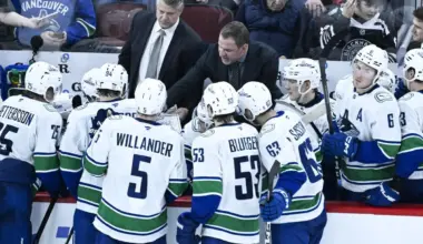 Vancouver Canucks head coach Adam Foote, right, talks with his team during the third period against the Chicago Blackhawks at United Center.