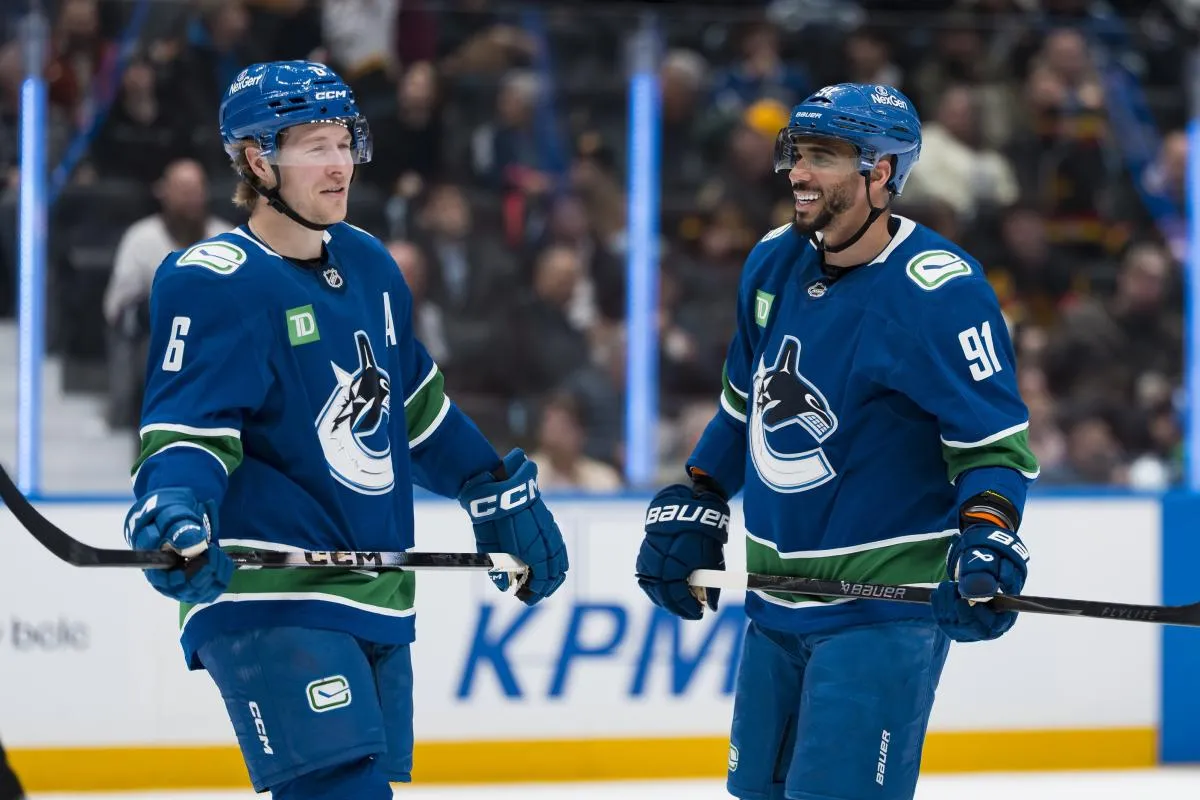 Vancouver Canucks forward Brock Boeser (6) and forward Evander Kane (91) share a smile during a stop in play against the Anaheim Ducks in the second period at Rogers Arena.