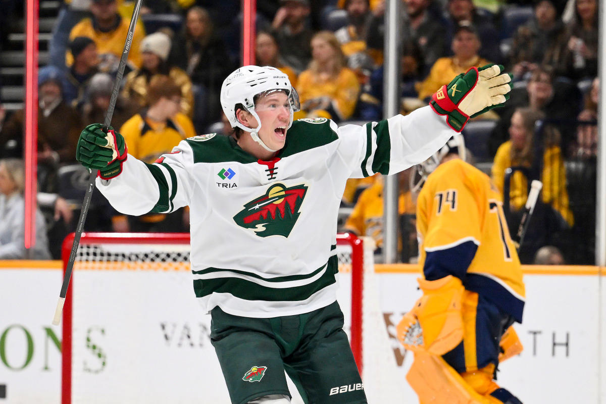 Feb 4, 2026; Nashville, Tennessee, USA; Minnesota Wild left wing Matt Boldy (12) celebrates defenseman Jared Spurgeon (46) winning goal against the Nashville Predators during the overtime period at Bridgestone Arena.Mandatory Credit: Steve Roberts-Imagn Images