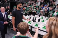 Boston Celtics forward Jayson Tatum, second from left, who has not played since injuring his...