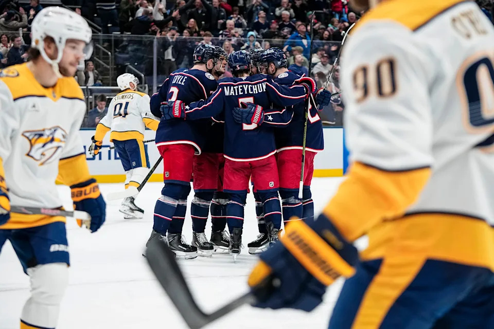 Teammates celebrate a goal by Columbus Blue Jackets center Charlie Coyle (3) during the third period of an NHL hockey game against the Nashville Predators at Nationwide Arena in Columbus on March 3, 2026. The Blue Jackets won 3-2 on the goal.