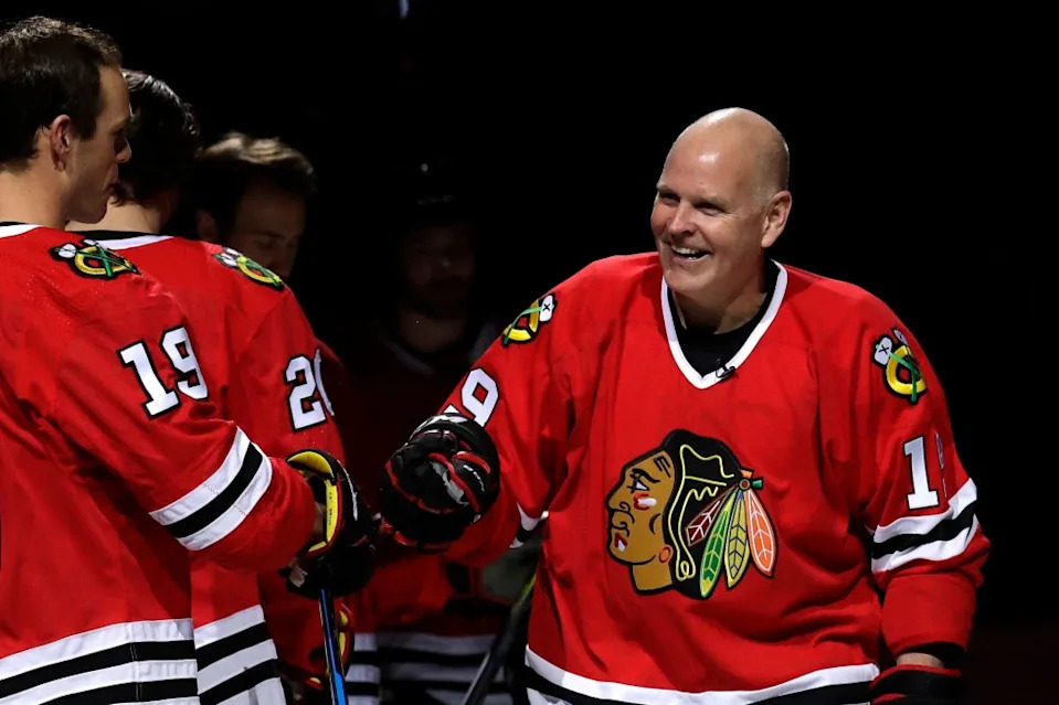 Troy Murray, right, greets Chicago Blackhawks center Jonathan Toews before an NHL hockey game against the Ottawa Senators, Wednesday, Feb. 21, 2018. AP
