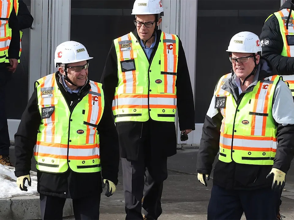 NHL commissioner Gary Bettman, left, leaves the Scotiabank Saddledome with Calgary Flames executives and others to tour the under-construction Scotia Place project on Tuesday, March 3, 2026.