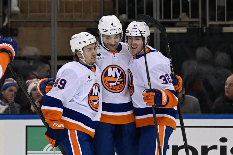 Jan 29, 2026; New York, New York, USA; New York Islanders right wing Max Shabanov (49) and New York Islanders center Kyle MacLean (32) celebrates the goal by New York Islanders defenseman Carson Soucy (4) against the New York Rangers during the second period at Madison Square Garden. Mandatory Credit: Dennis Schneidler-Imagn Images