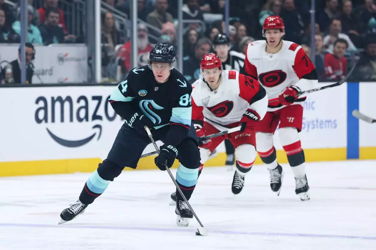 FILE - Seattle Kraken right wing Kaapo Kakko (84) breaks away with the puck during the first period of an NHL hockey game against the Carolina Hurricanes, March 2, 2026, in Seattle. (AP Photo/Kevin Ng, File)