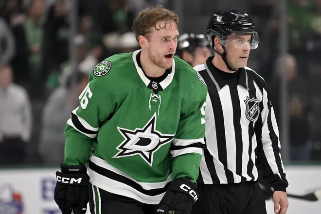 Nov 18, 2025; Dallas, Texas, USA; Dallas Stars right wing Mikko Rantanen (96) is led off the ice after he receives a game misconduct penalty for boarding on New York Islanders defenseman Alexander Romanov (not pictured) during the third period at the American Airlines Center.
