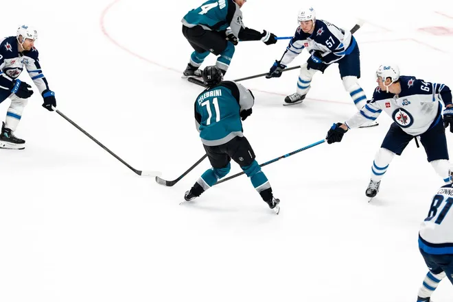 March 1, 2026; San Jose, California, USA; San Jose Sharks center Macklin Celebrini (71) shoots the puck against Winnipeg Jets defenseman Elias Salomonsson (57) during the third period at SAP Center at San Jose.