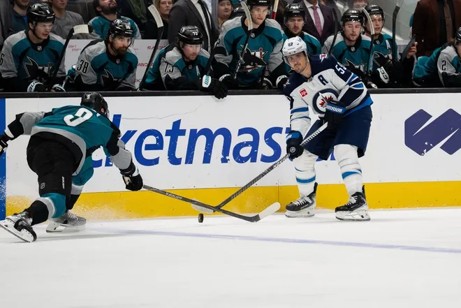 Feb 28, 2026; San Jose, California, USA; Winnipeg Jets center Mark Scheifele (55) looks to pass the puck against San Jose Sharks defenseman Dmitry Orlov (9) during the first period at SAP Center at San Jose.