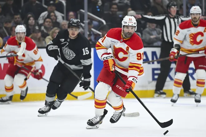 Feb 28, 2026; Los Angeles, California, USA; Calgary Flames center Nazem Kadri (91) skates with the puck during the first period against the Los Angeles Kings at Crypto.com Arena.