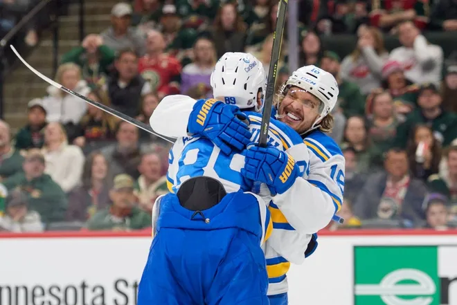Mar 1, 2026; Saint Paul, Minnesota, USA; St. Louis Blues left wing Pavel Buchnevich (89) celebrates with center Robert Thomas (18) after scoring on the Minnesota Wild in the third period at Grand Casino Arena.