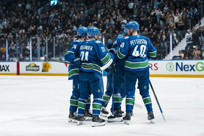 Mar 4, 2026; Vancouver, British Columbia, CAN; Vancouver Canucks defenseman Zeev Buium (24) and forward Nils Hoglander (21) and defenseman Filip Hronek (17) and forward Elias Pettersson (40) celebrate Hoglander’s goal against the Carolina Hurricanes in the third period at Rogers Arena.