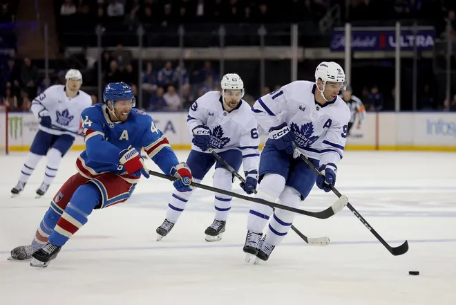 Mar 5, 2026; New York, New York, USA; Toronto Maple Leafs center John Tavares (91) controls the puck against New York Rangers defenseman Vladislav Gavrikov (44) during the third period at Madison Square Garden.