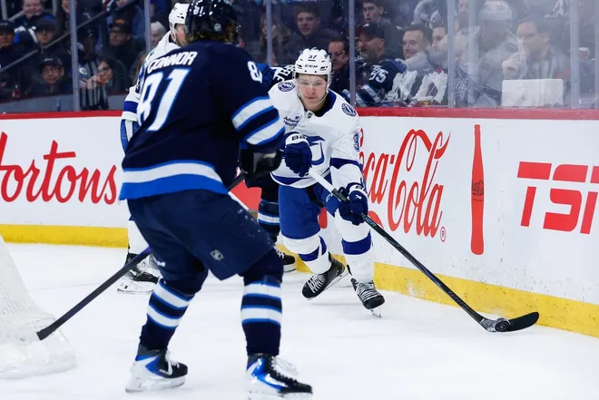 Mar 5, 2026; Winnipeg, Manitoba, CAN; Tampa Bay Lightning forward Yanni Gourde (37) looks to make a pass by Winnipeg Jets forward Kyle Connor (81) during the second period at Canada Life Centre.
