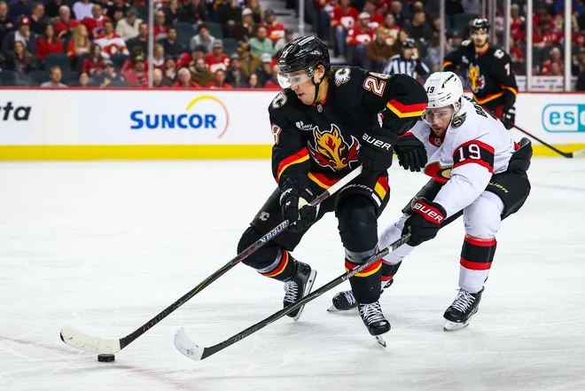 Mar 5, 2026; Calgary, Alberta, CAN; Calgary Flames defenseman Zach Whitecloud (28) controls the puck against Ottawa Senators right wing Drake Batherson (19) during the third period at Scotiabank Saddledome.