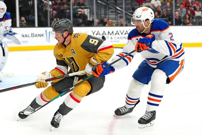 Mar 8, 2026; Las Vegas, Nevada, USA; Vegas Golden Knights center Jack Eichel (9) skates ahead of Edmonton Oilers defenseman Evan Bouchard (2) during the third period at T-Mobile Arena.