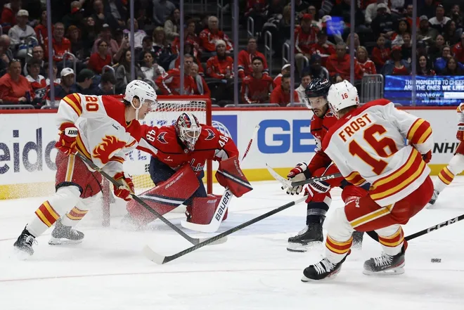 Mar 9, 2026; Washington, District of Columbia, USA; Washington Capitals goaltender Logan Thompson (48) follows the puck as Calgary Flames center Morgan Frost (16) makes a pass during the second period at Capital One Arena.